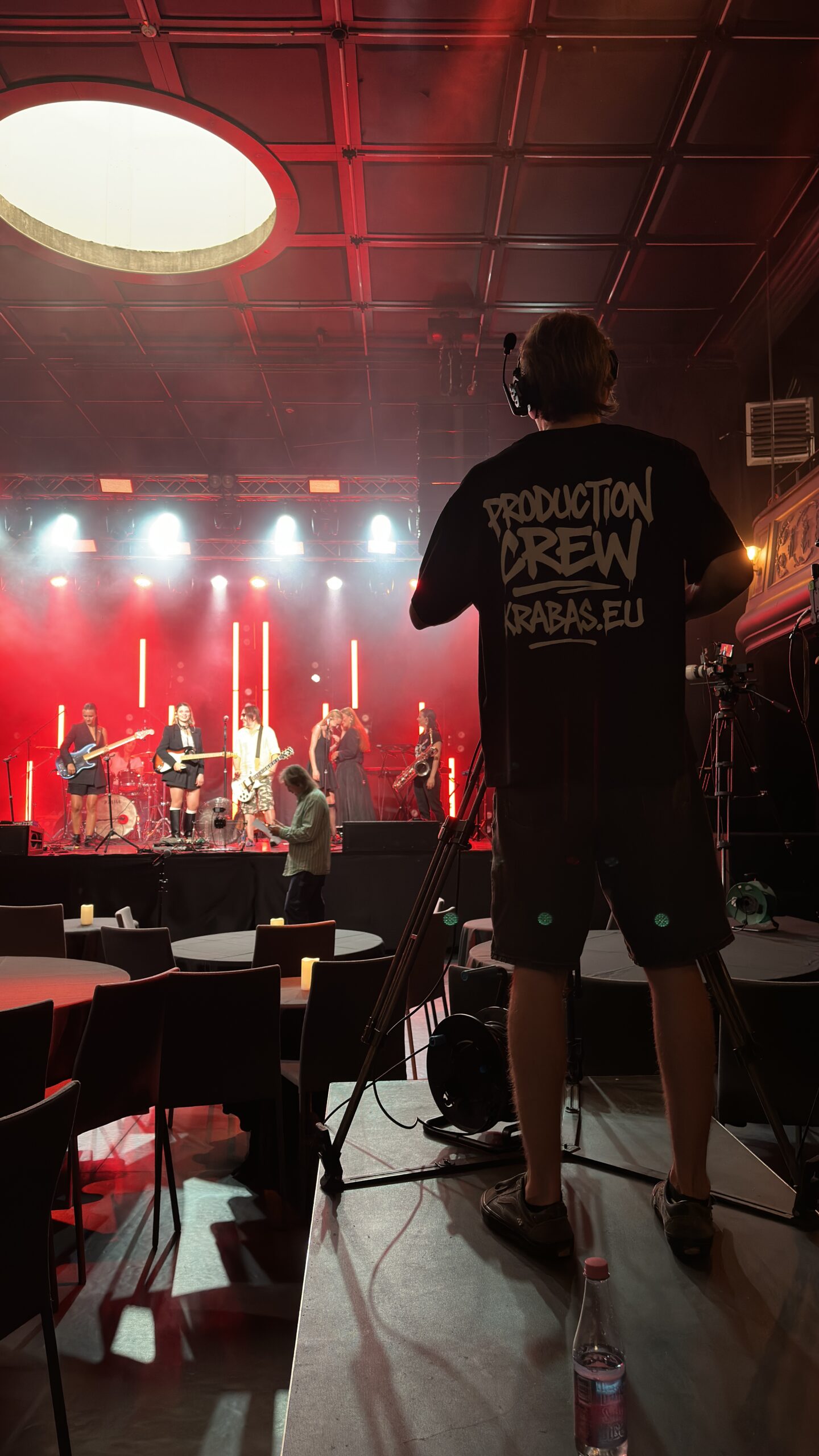 Camera operator covering the stage from a raised position