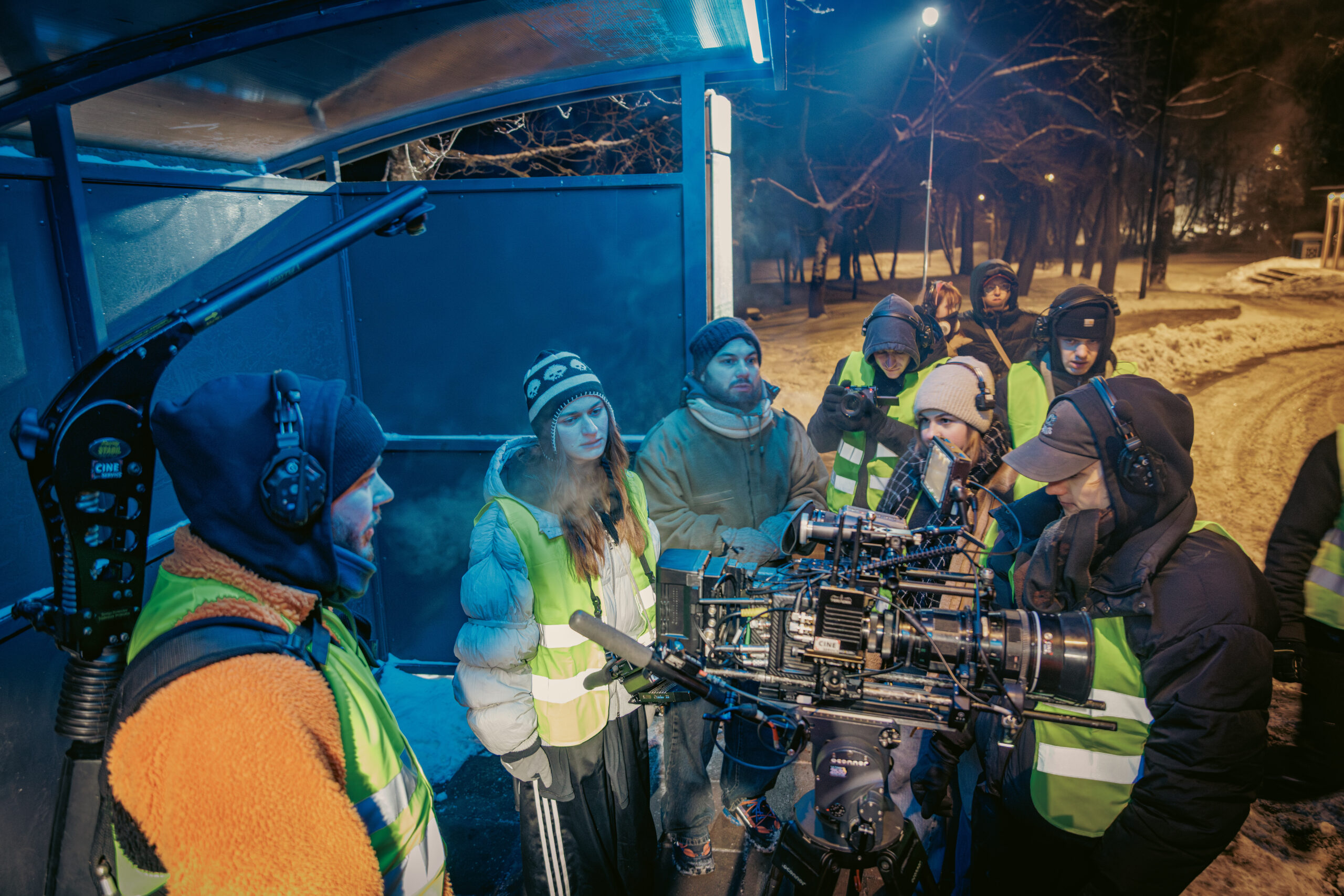 Crew checking the camera at the snowy bus stop