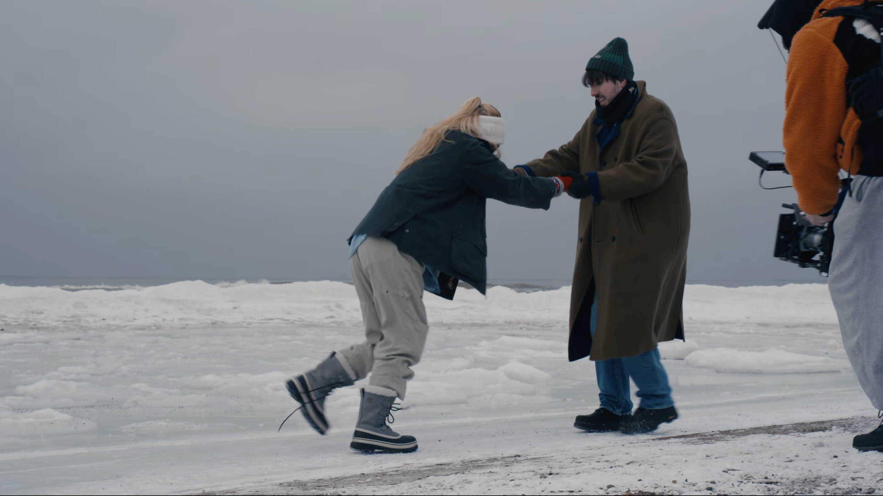 Performers between takes on the snowy Baltic shore