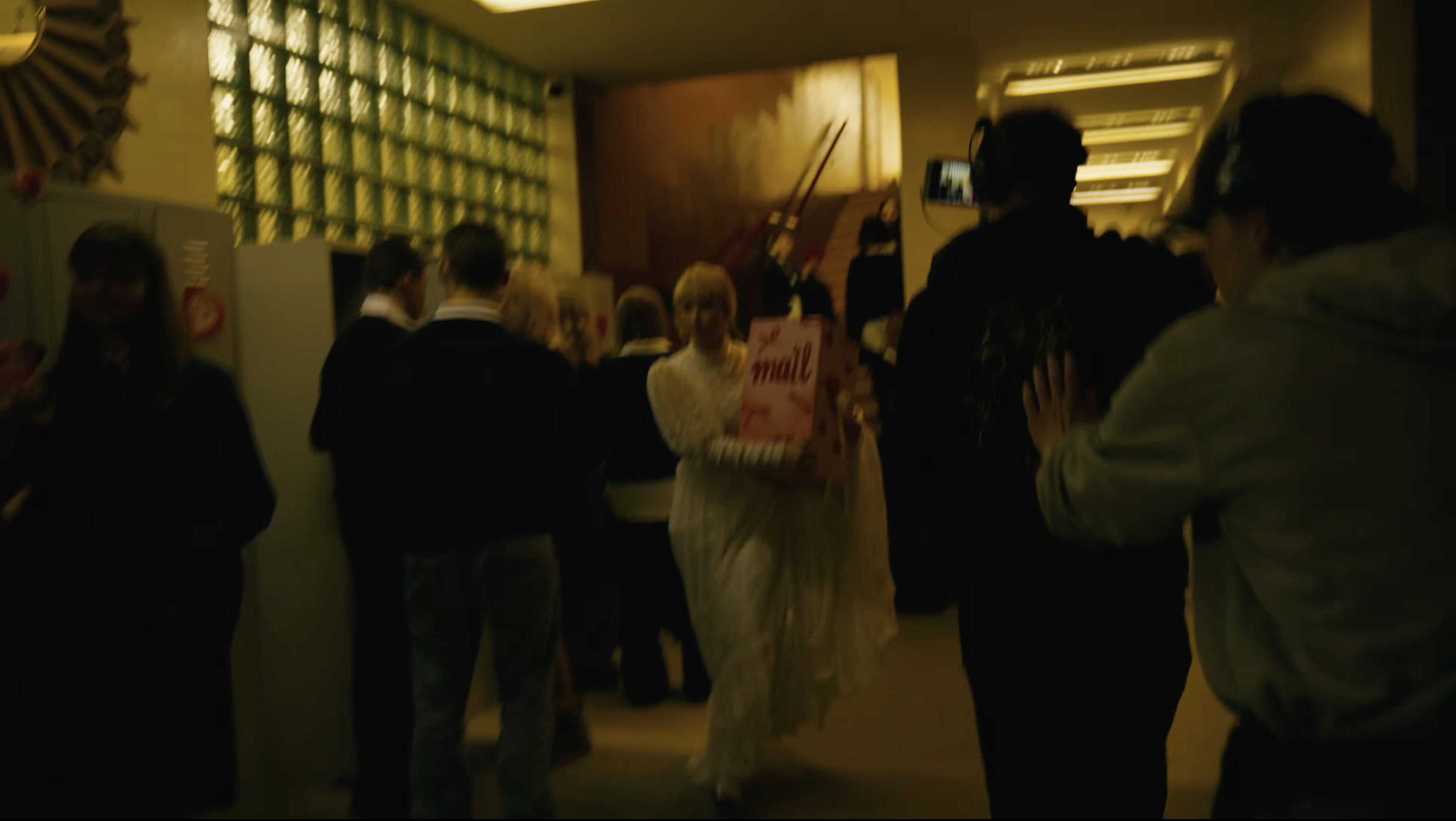 Camera crew filming Monetochka in the school corridor
